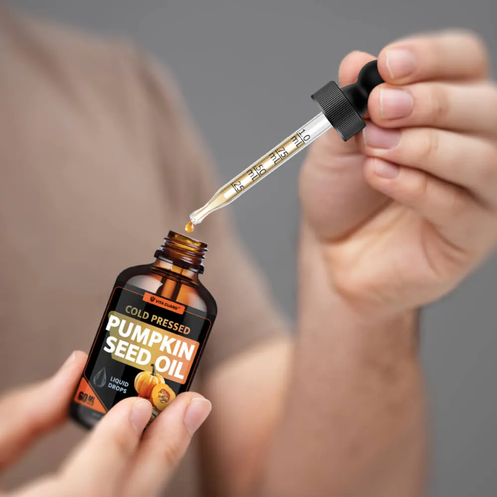 Hand using a Vita Guard liquid supplement dropper